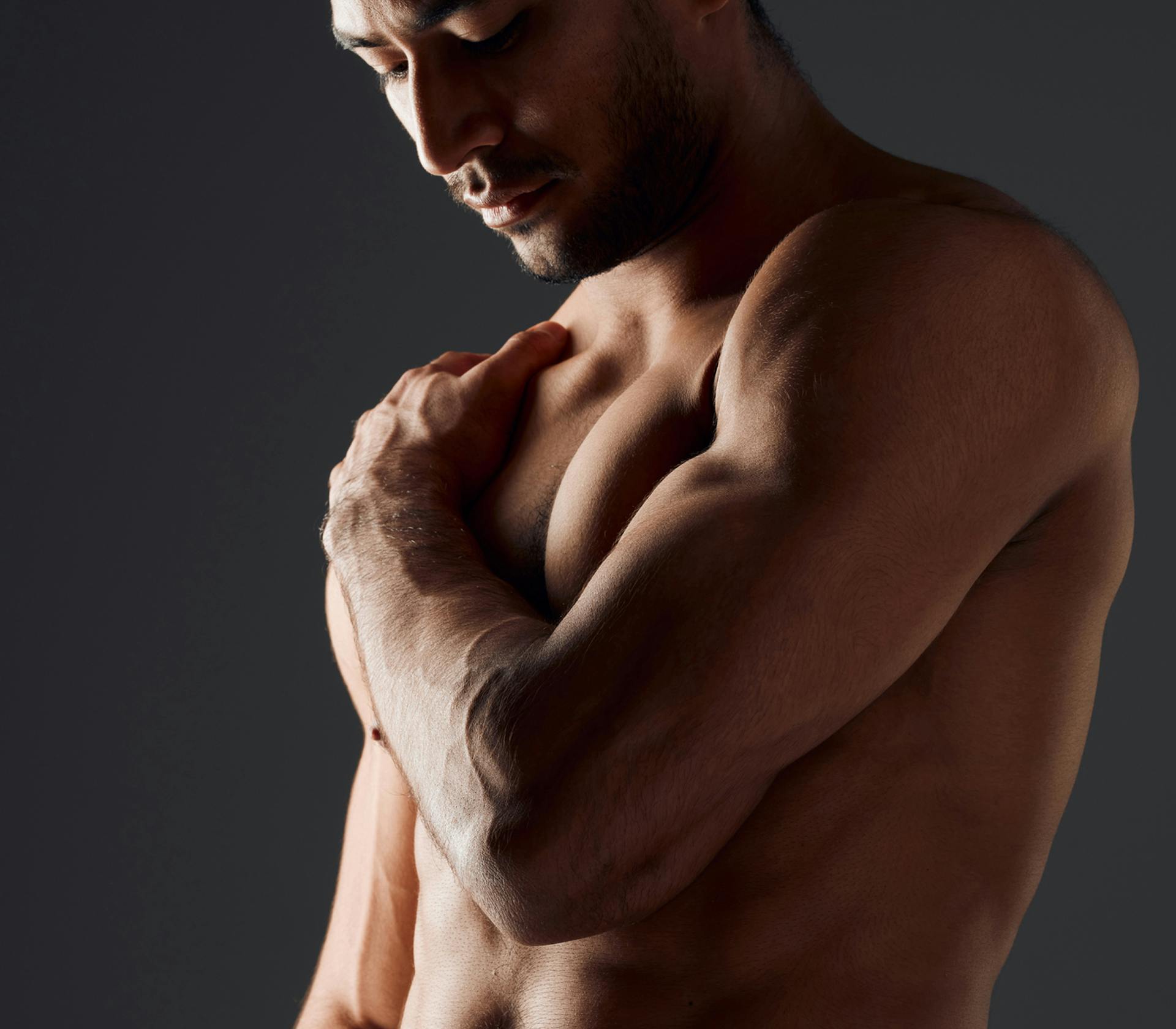 man grabbing his shoulder