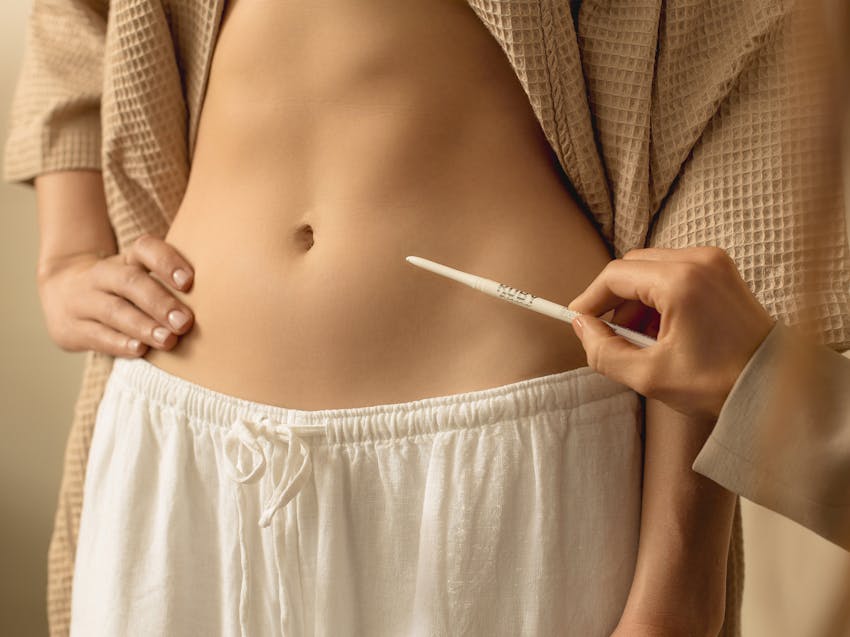 woman showing her stomach to a doctor