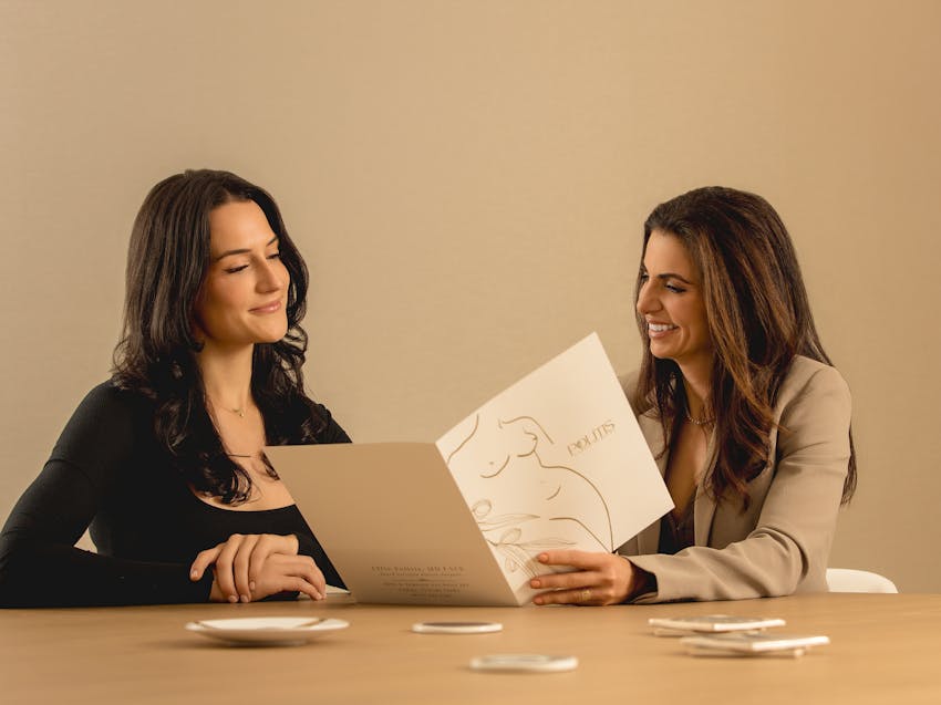 two women looking at a pamphlet