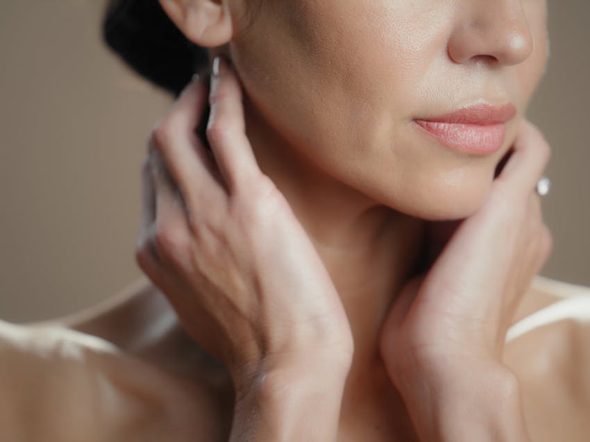 woman holding her neck