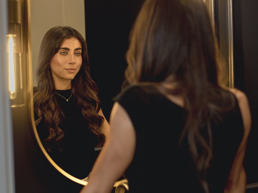 woman looking into a mirror