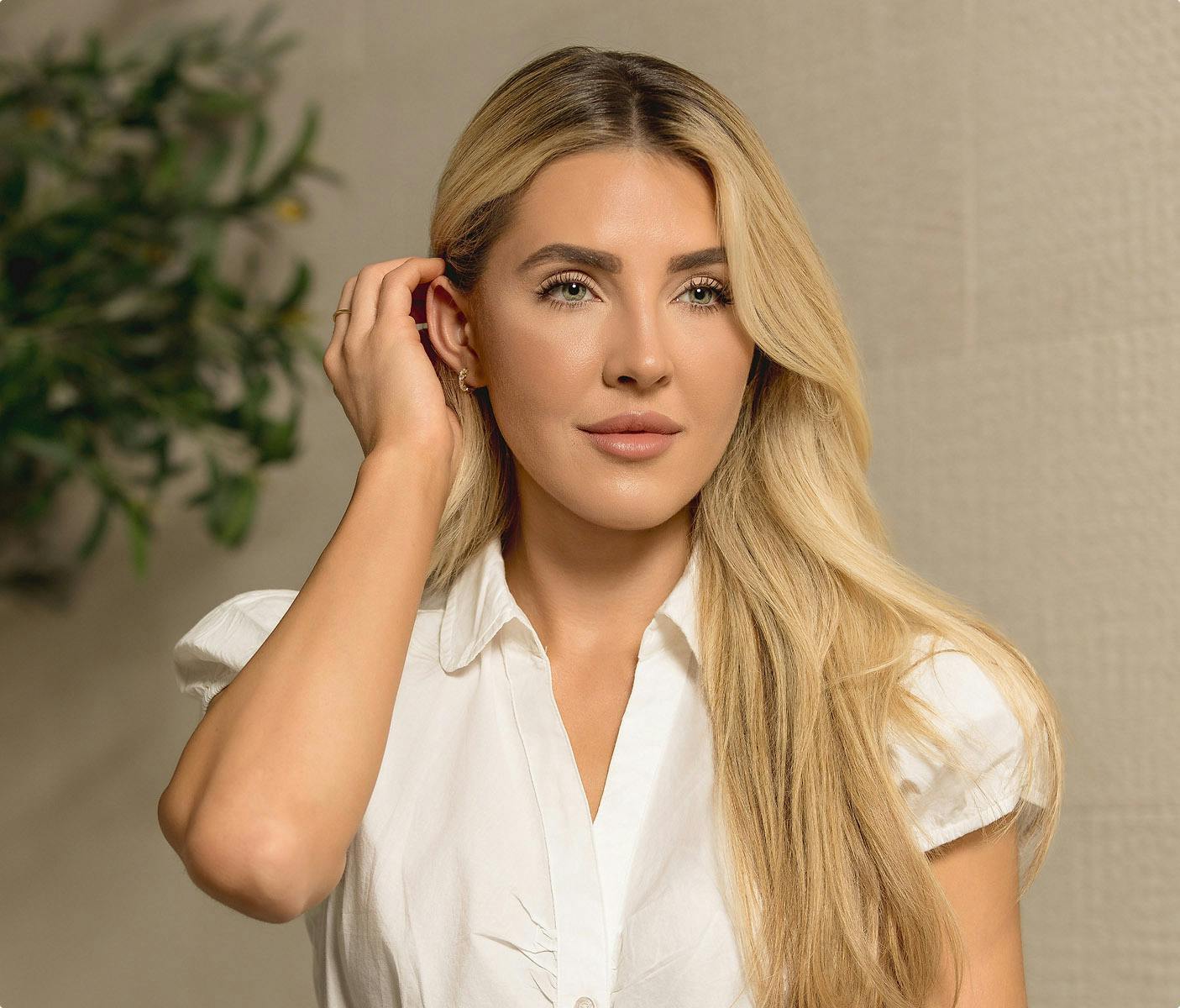 woman with blonde hair wearing a white shirt