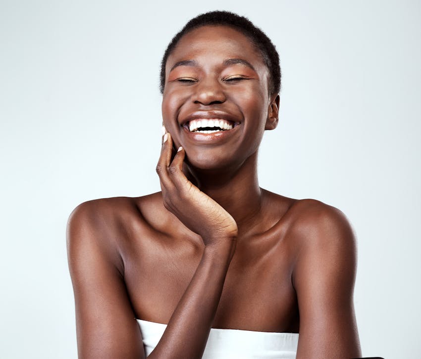 Woman smiling and touching chin