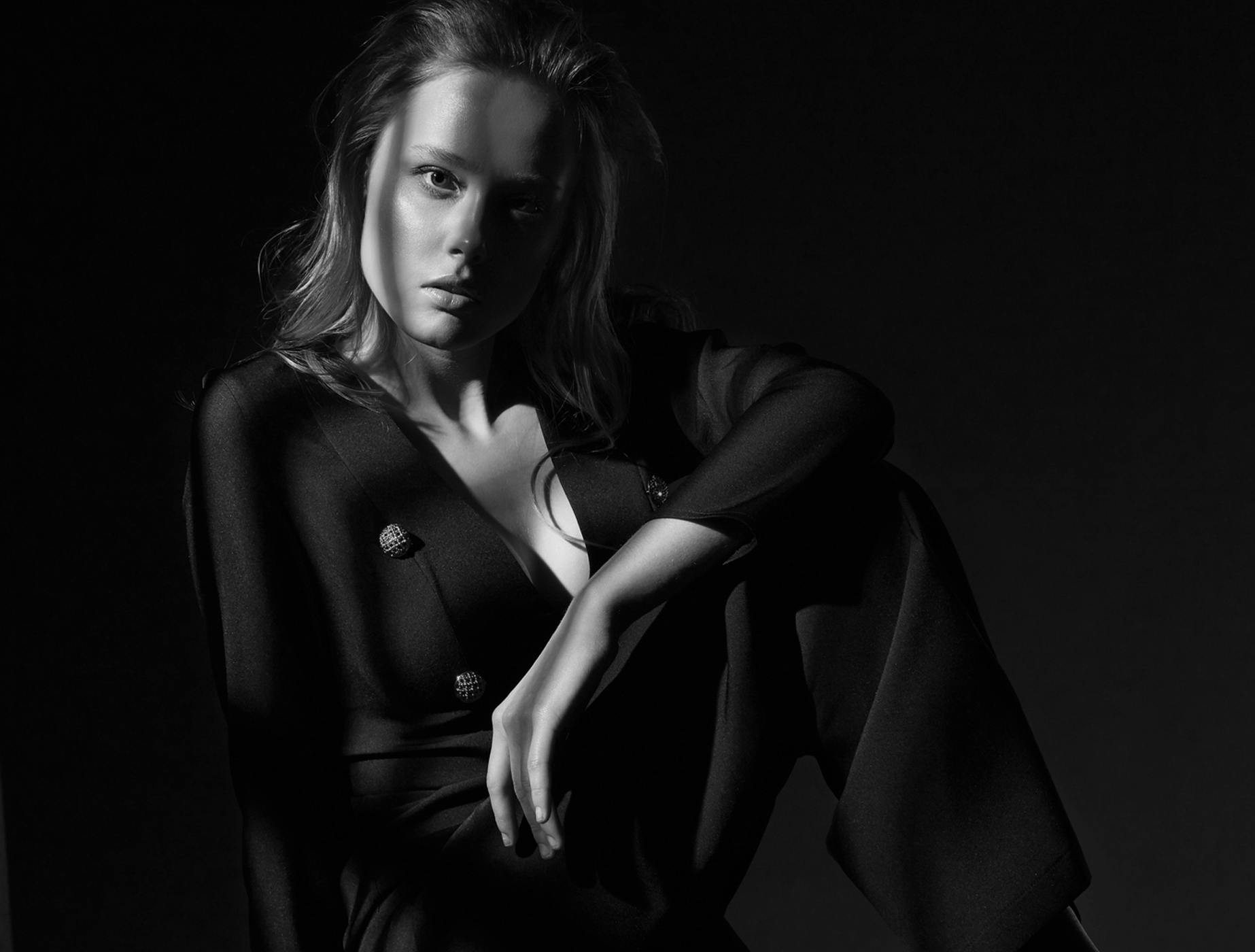 woman sitting in black and white