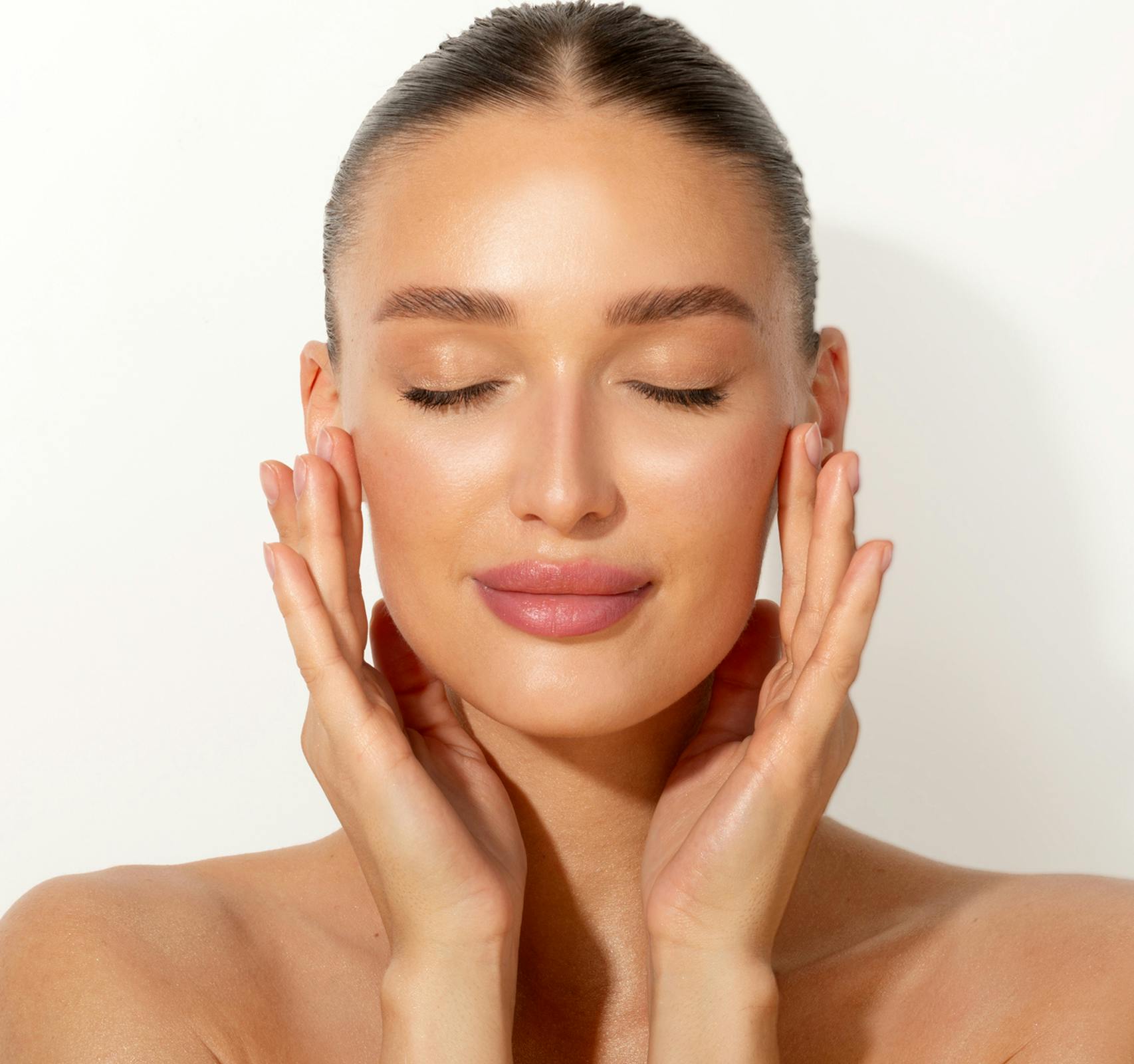 woman with hands on face and eyes closed