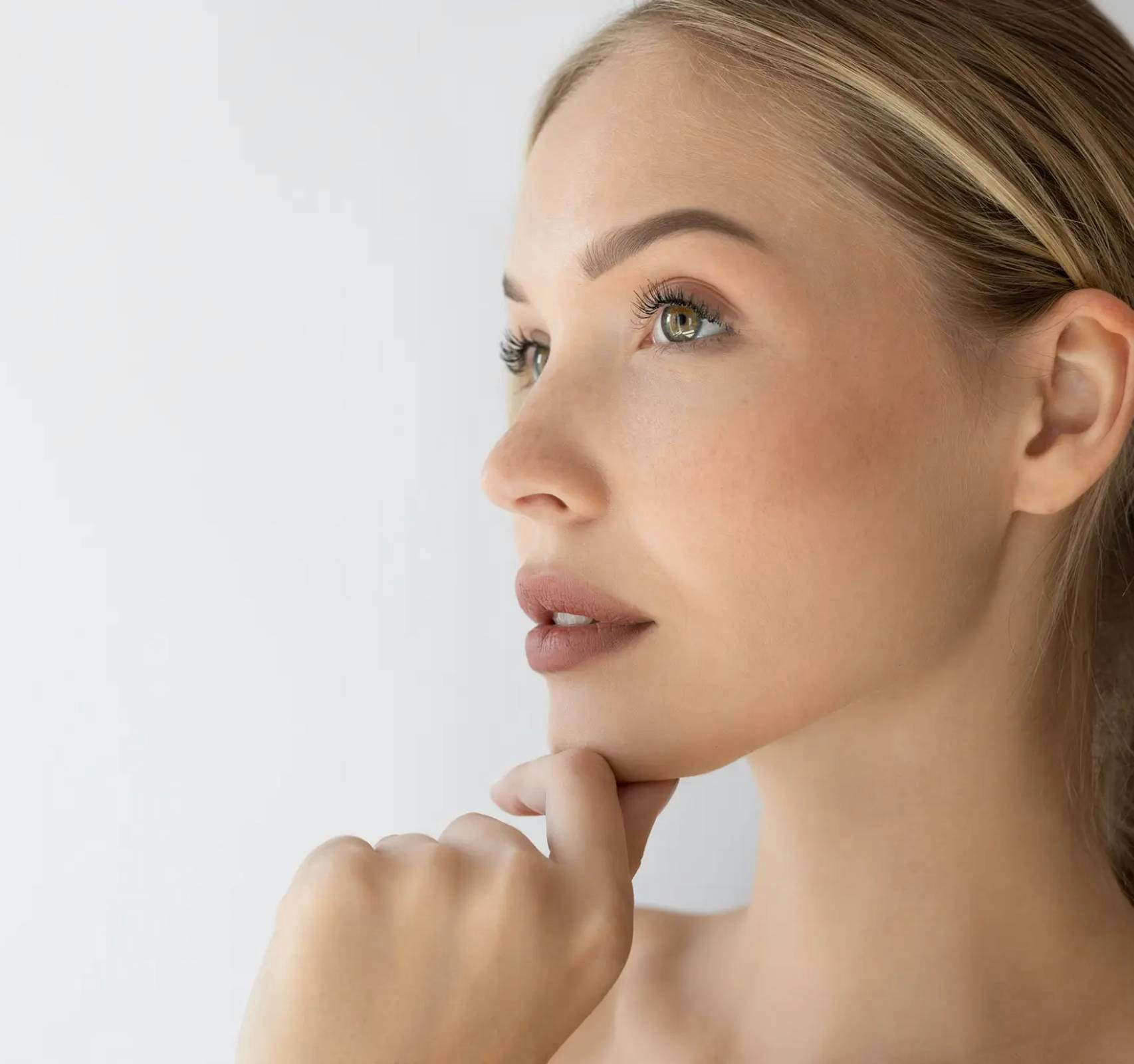 womans side profile with hand on chin