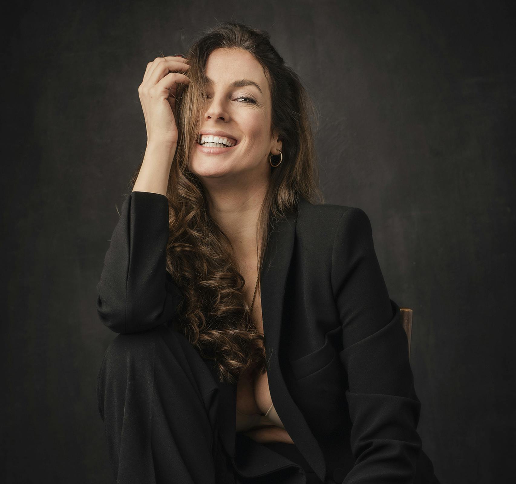 woman smiling with hand on face