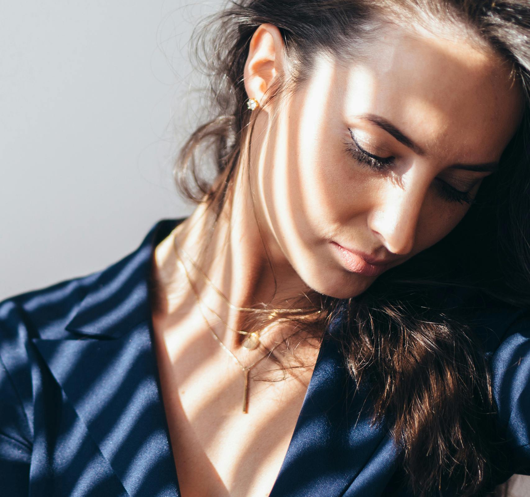 woman looking down with shadow cast on face