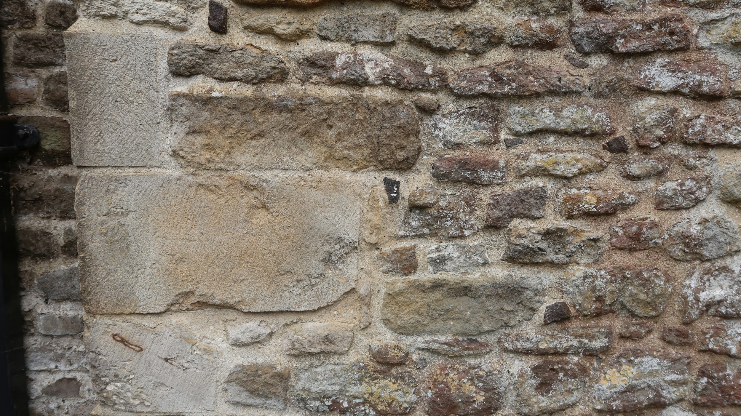 Stone blocks form a rustic building's exterior.