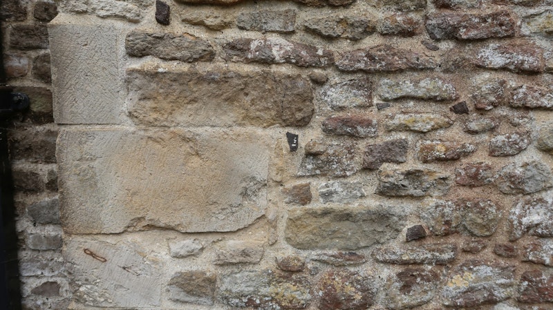 Stone blocks form a rustic building's exterior.