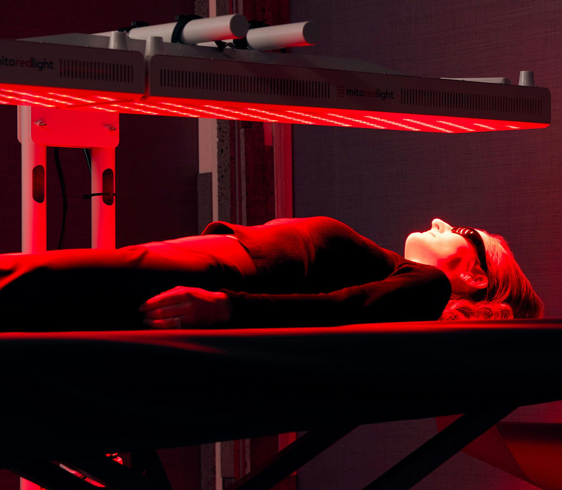 woman laying in red light
