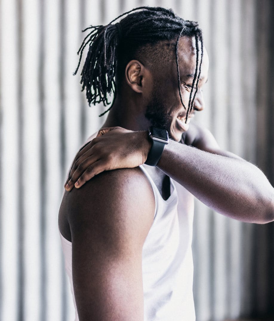 man grabbing his shoulder