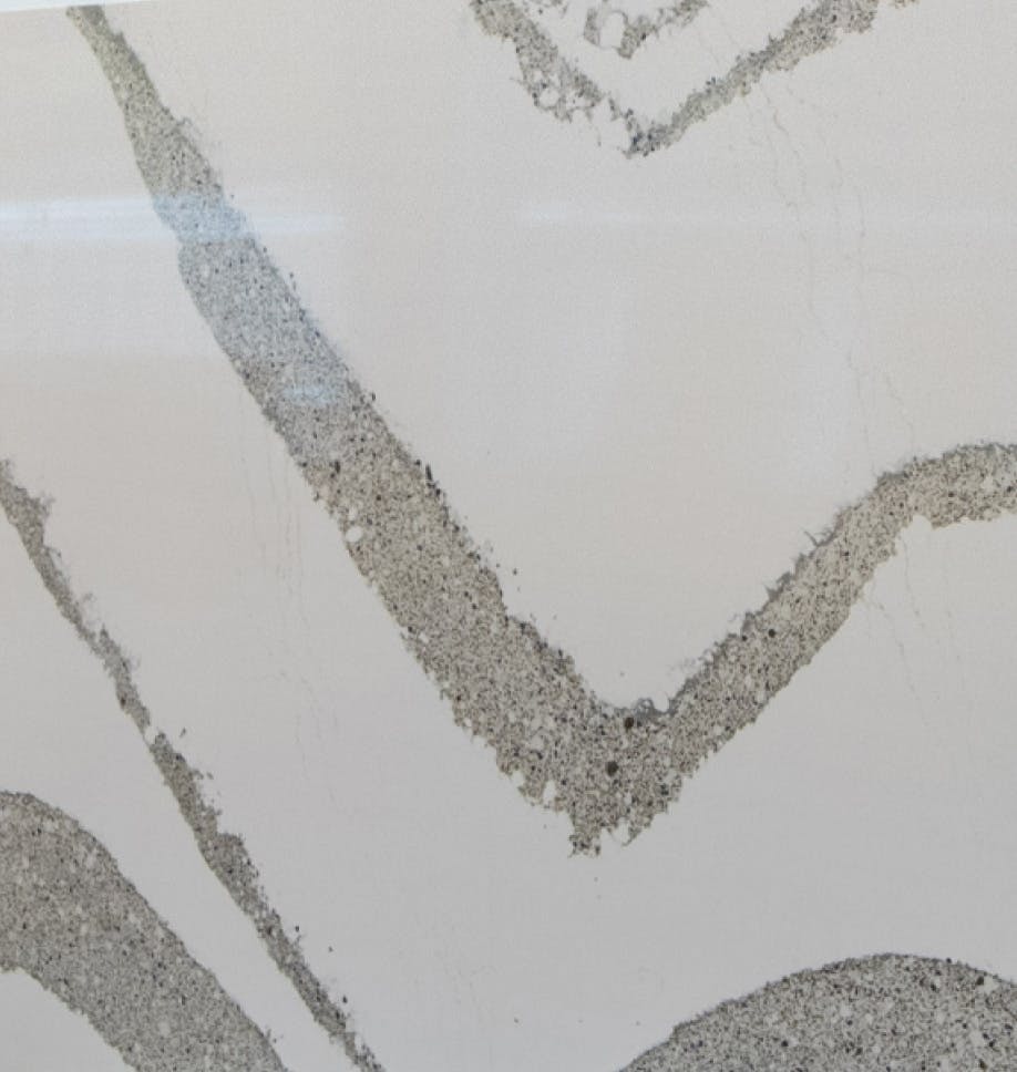 there is a picture of a white marble counter top with a black and white design