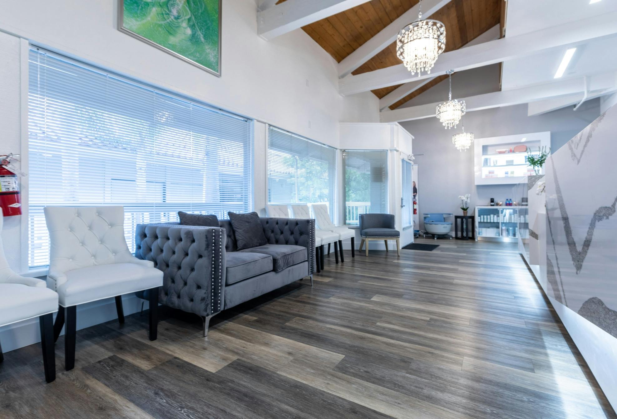 there is a room with a couch, chairs, and a chandelier