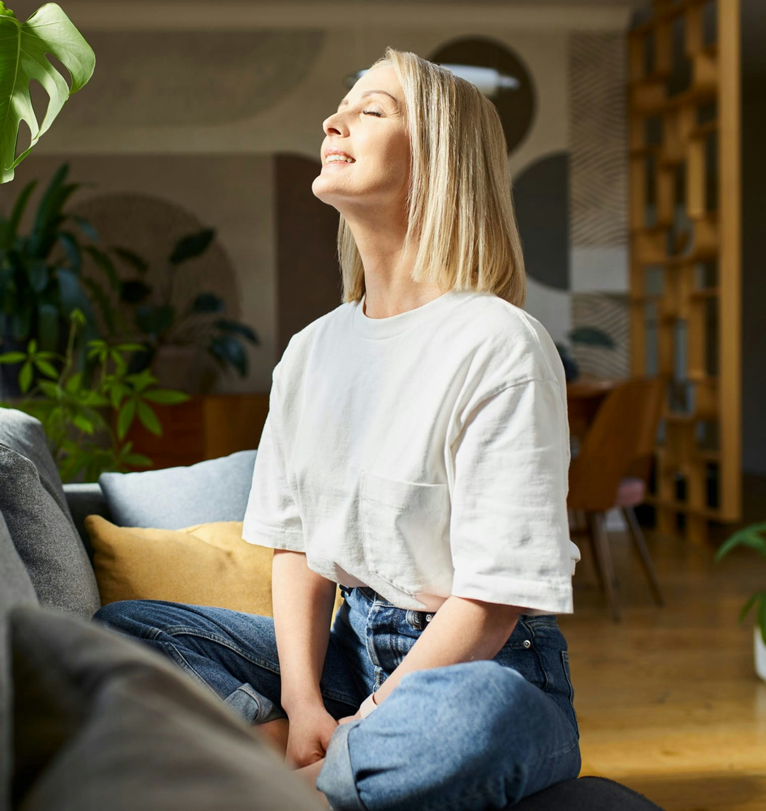 Woman sitting down facing the sun