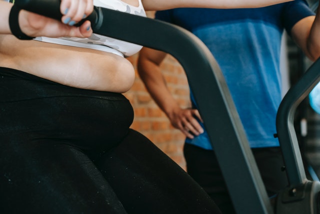 Woman with cellulite touching legs