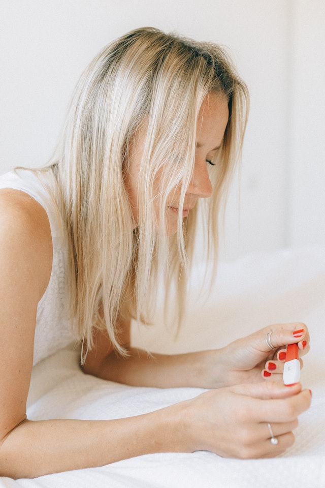 woman looking at pregnancy test