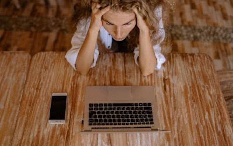 woman stressing out and looking at laptop