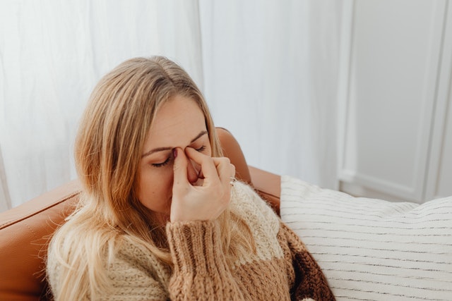 woman pinching her nose