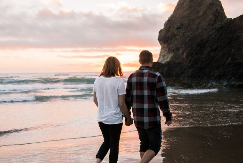 couple walking on the beach holding hands