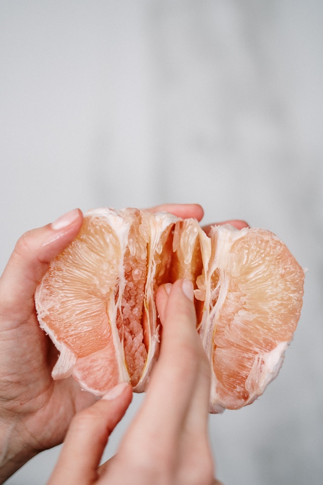 hands peeling orange