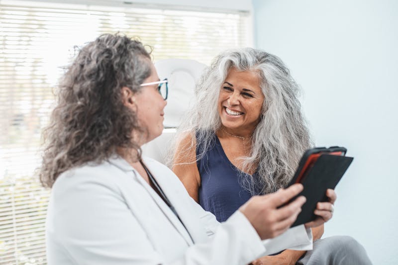 Dr. Mirela Cernaianu speaking to patient