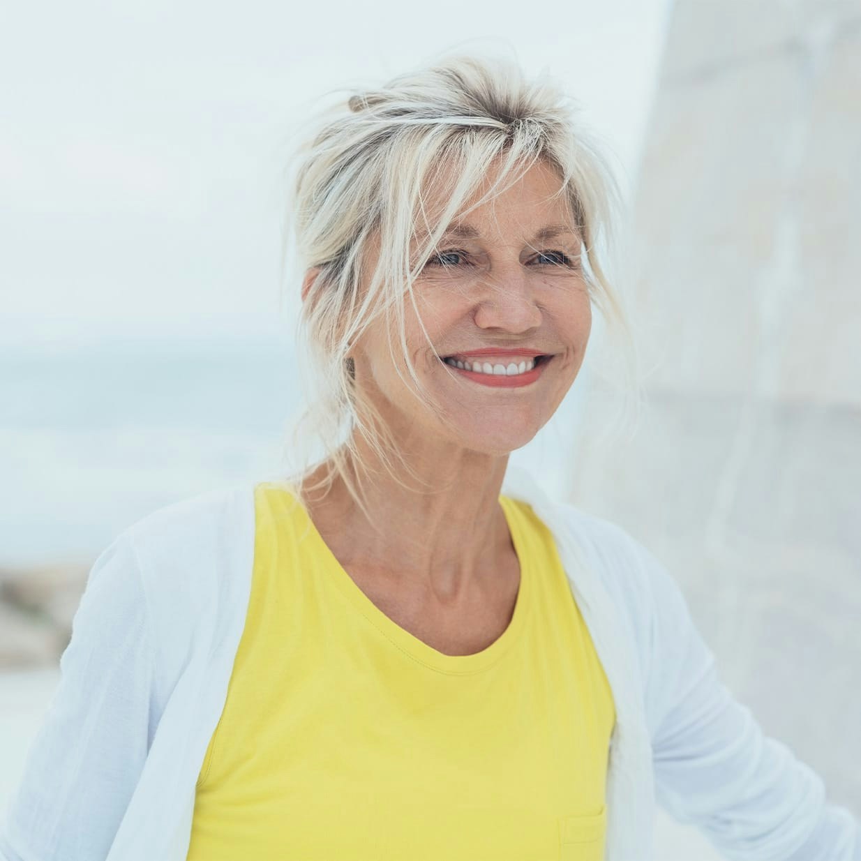 Smiling woman wearing yellow shirt