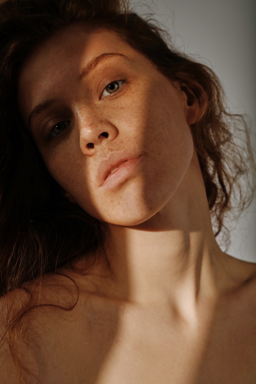 Woman with beautiful skin looks at camera seductively in a studio shoot to emulate the potential results of a PicoSure laser treatment in Thousand Oaks