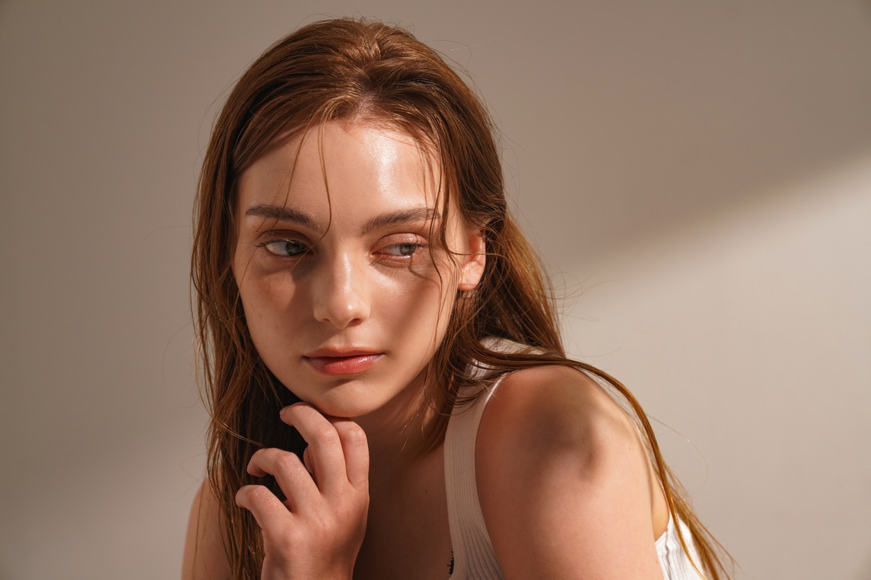 Woman with beautiful skin looks at away from camera seductively in a studio shoot to emulate the potential results of a PicoSure laser treatment in Thousand Oaks