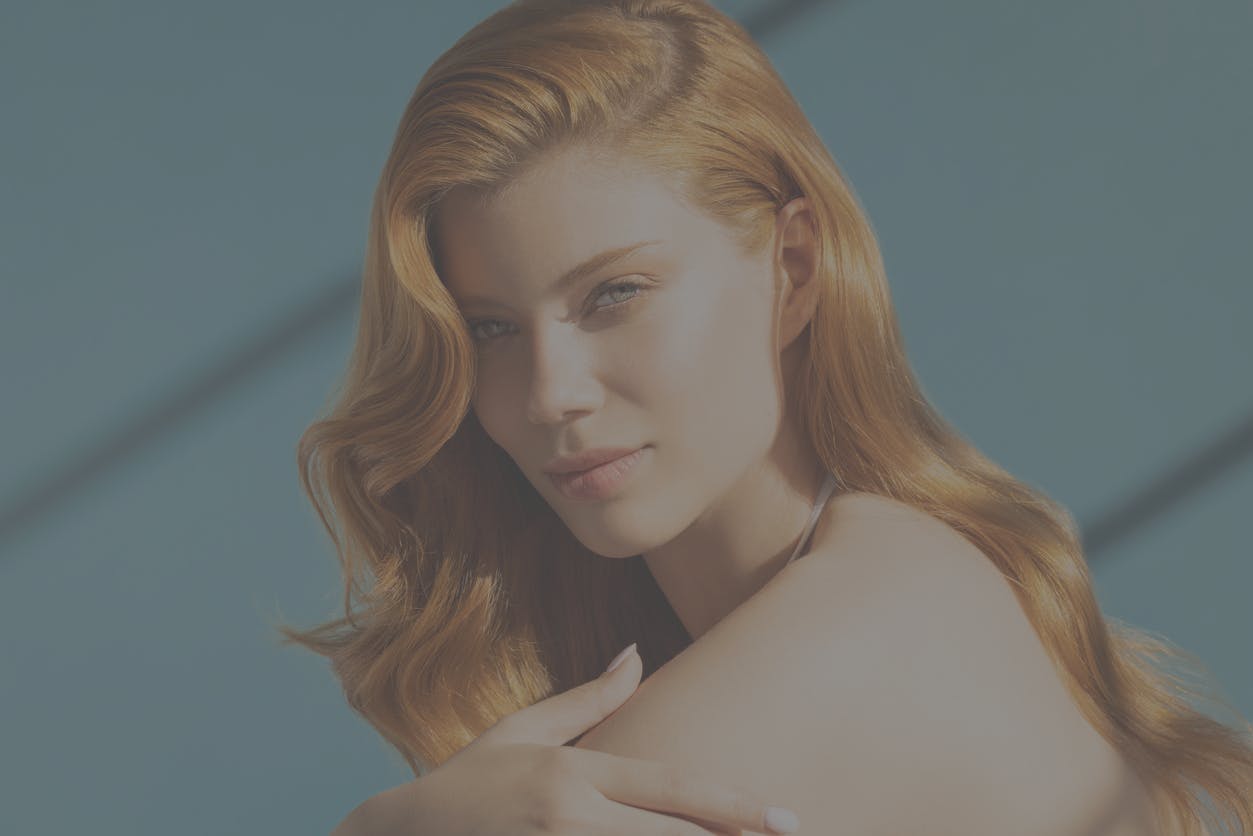 Woman with beautiful skin looks at camera seductively in a studio shoot to emulate the potential results of a PicoSure laser treatment in Thousand Oaks