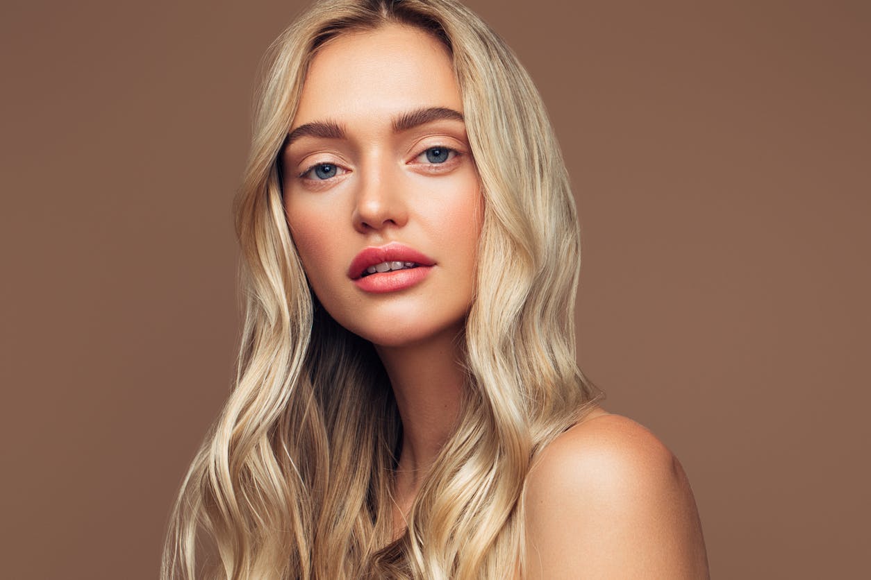 Woman with beautiful skin looks at camera seductively in a studio shoot to emulate the potential results of a PicoSure laser treatment in Thousand Oaks