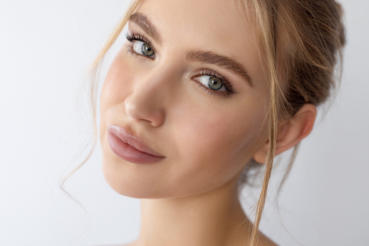 Woman with perfect skin has a small smile while looking at the camera. Her youthful skin emulates the potential results Fractional Laser Skin Resurfacing in Thousand Oaks