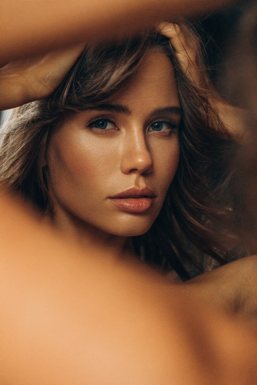 Woman with perfect skin looks seductively at the camera wiht her hands up over her head. Her youthful skin emulates the potential results Fractional Laser Skin Resurfacing in Thousand Oaks