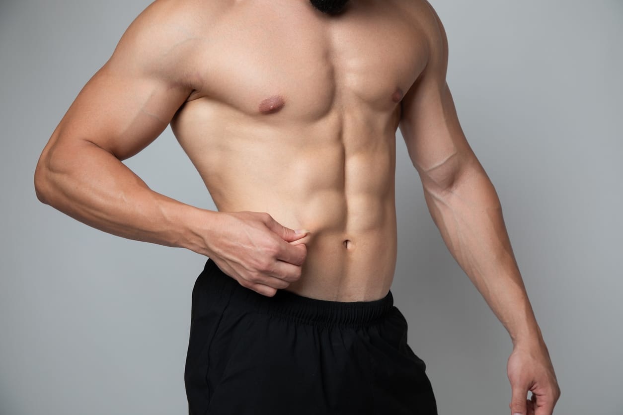 fit man pinching abs