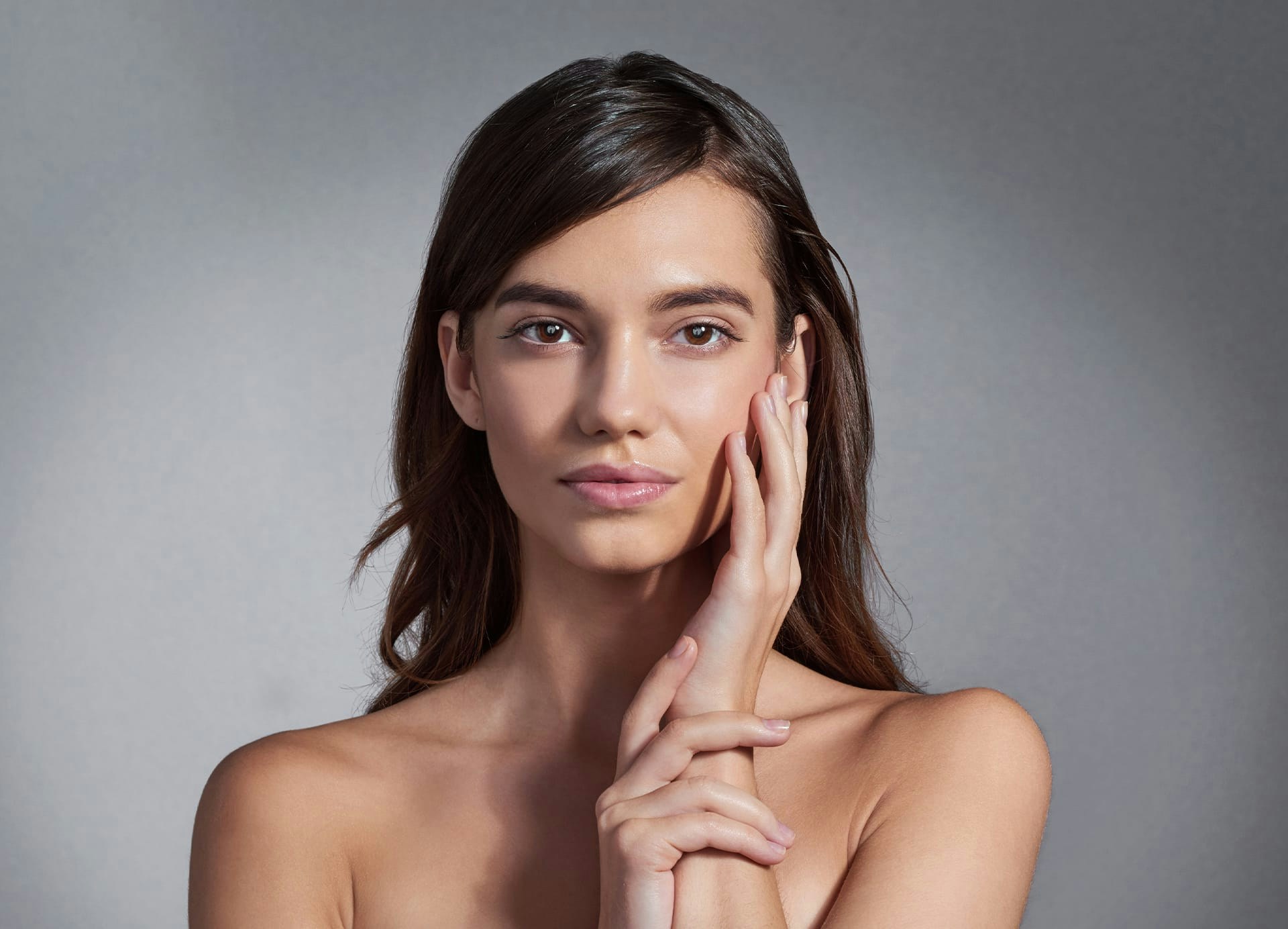 Woman running hand over her cheek