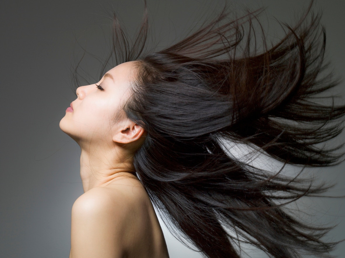 woman with beautiful healthy hair blowing in the air