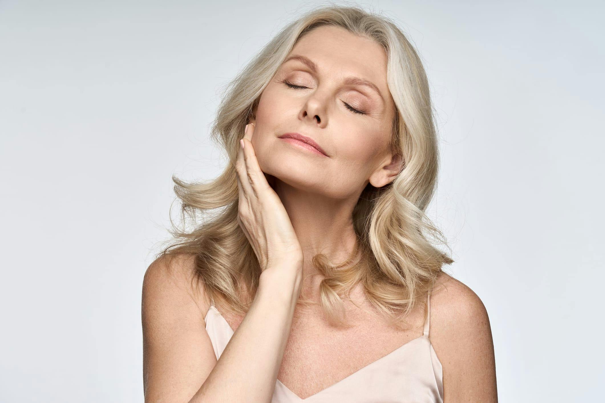 Woman feeling her cheek