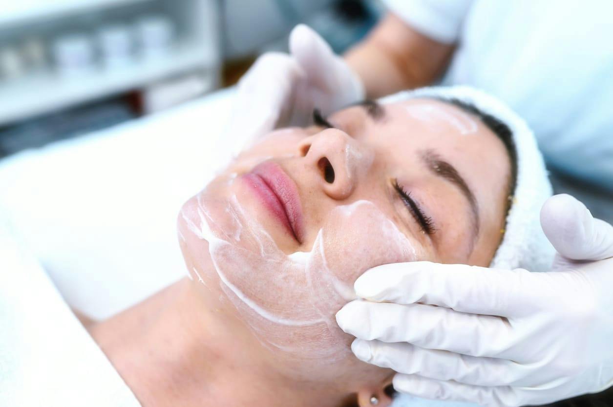 Woman receiving facial treatment