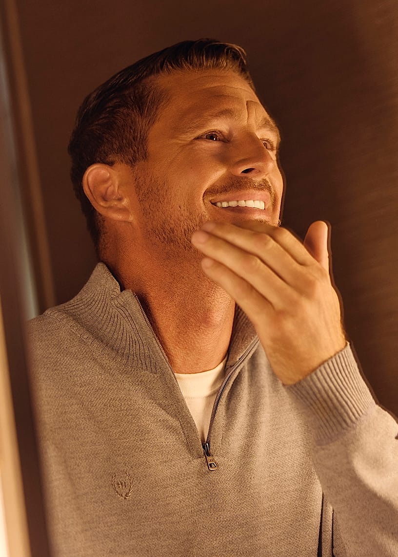 man touching his face