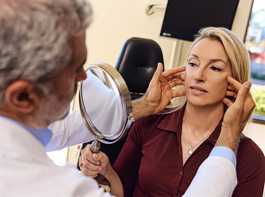 Dr.Karam touching a patients face