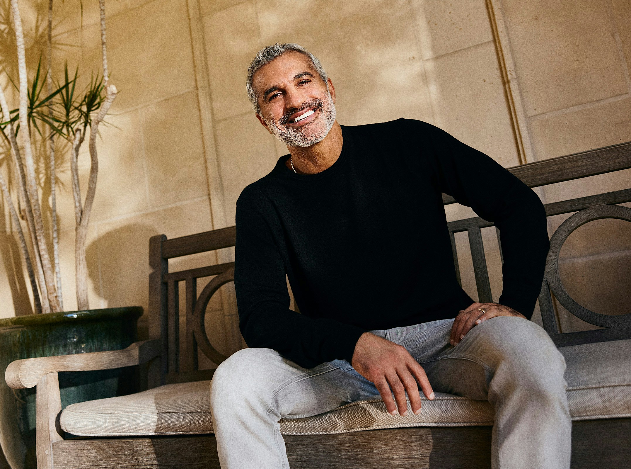 Dr.Karam sitting down and smiling