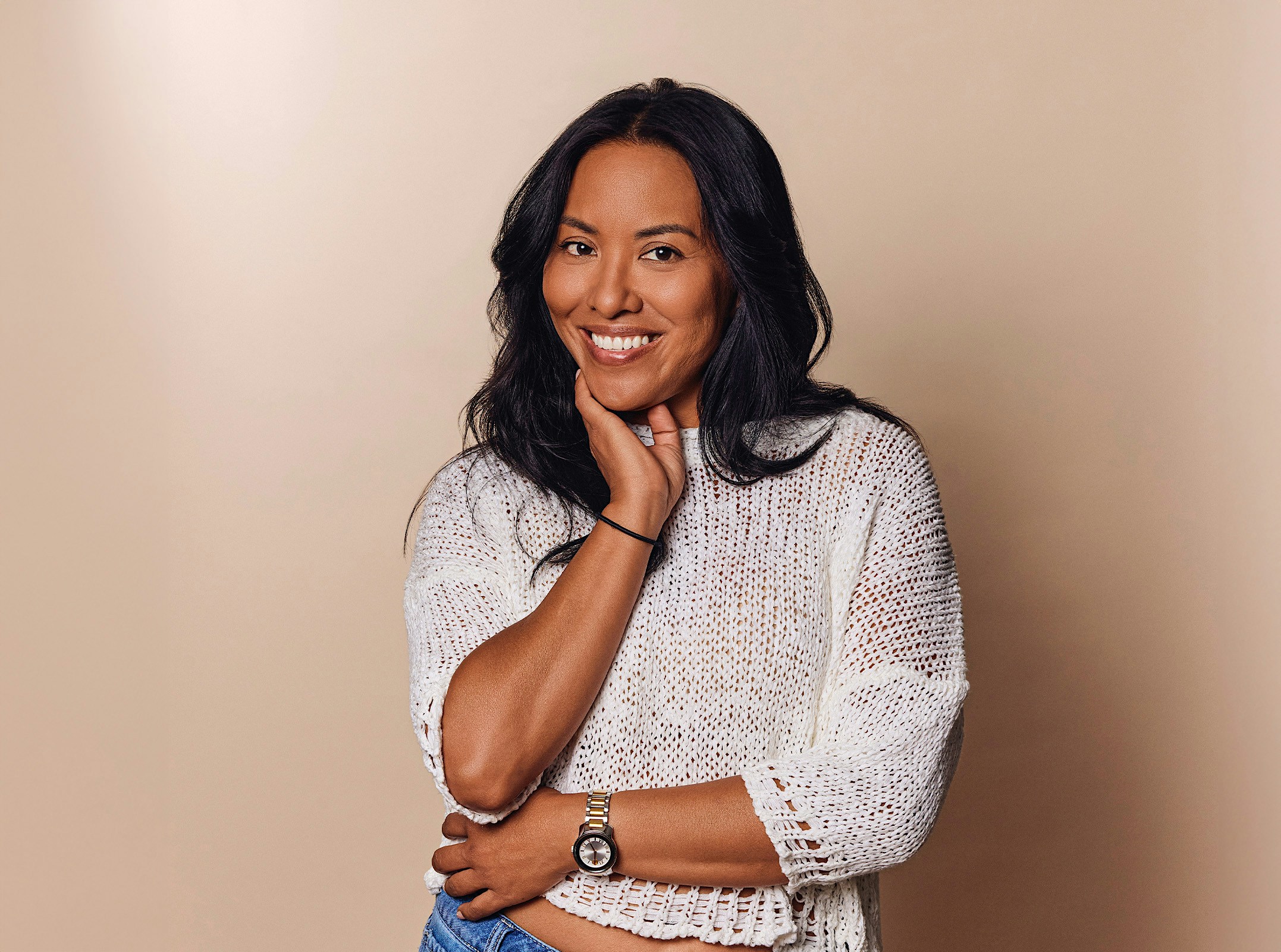 Woman smiling and touching her chin