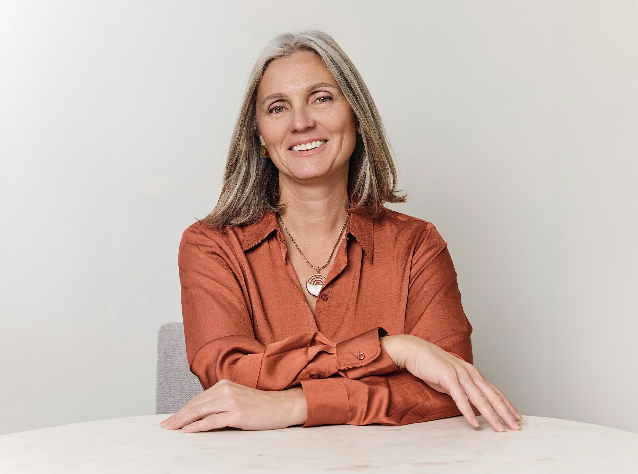 Woman smiling with her arms crossed