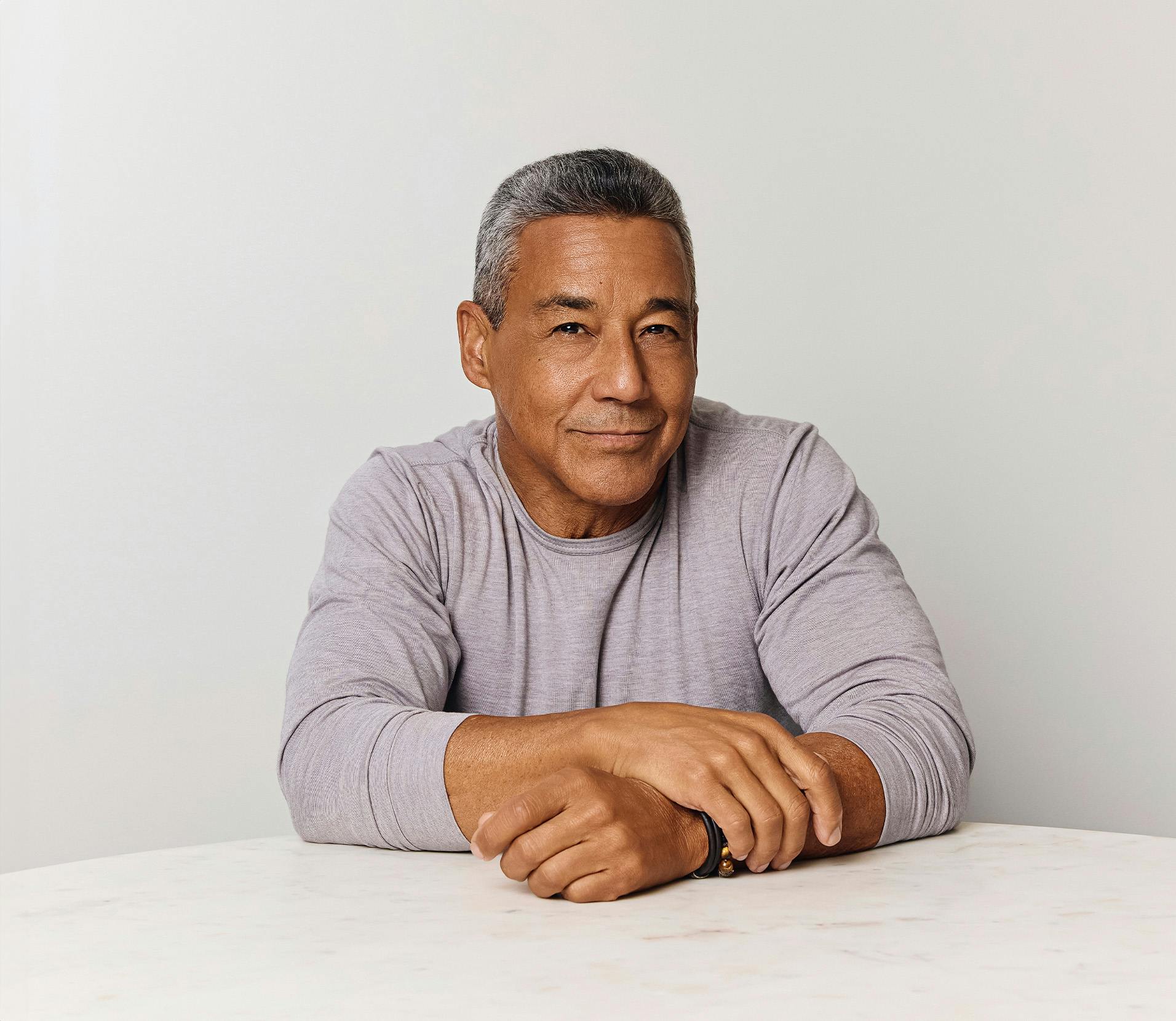 Man smiling with his hands crossed