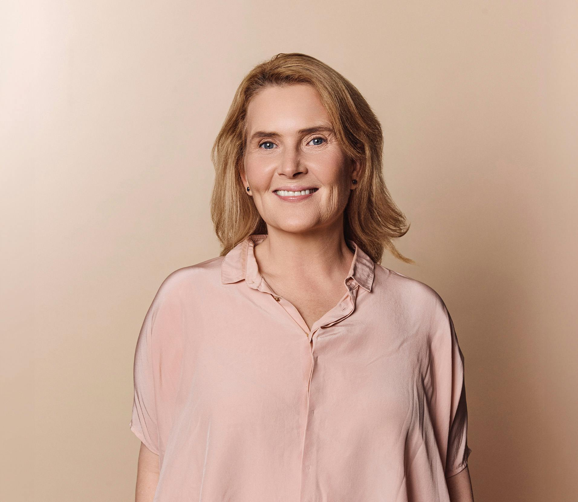 Woman in a pink shirt smiling