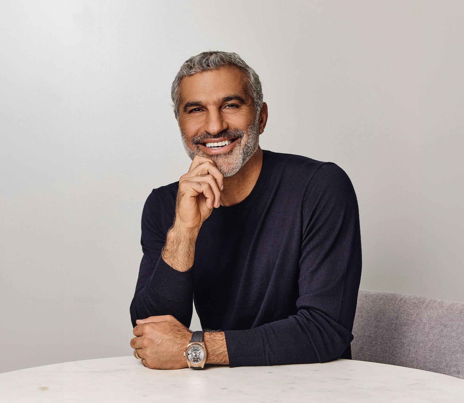 Dr. Karam smiling with his hand touching his chin