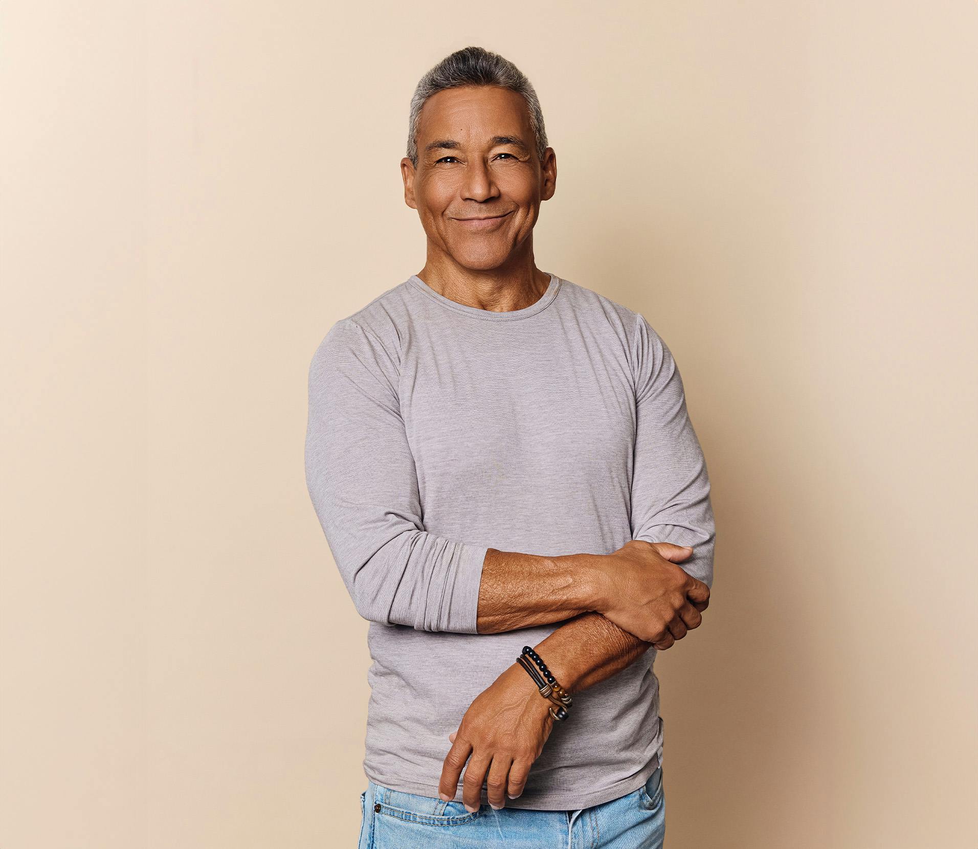 Man smiling and holding his arm