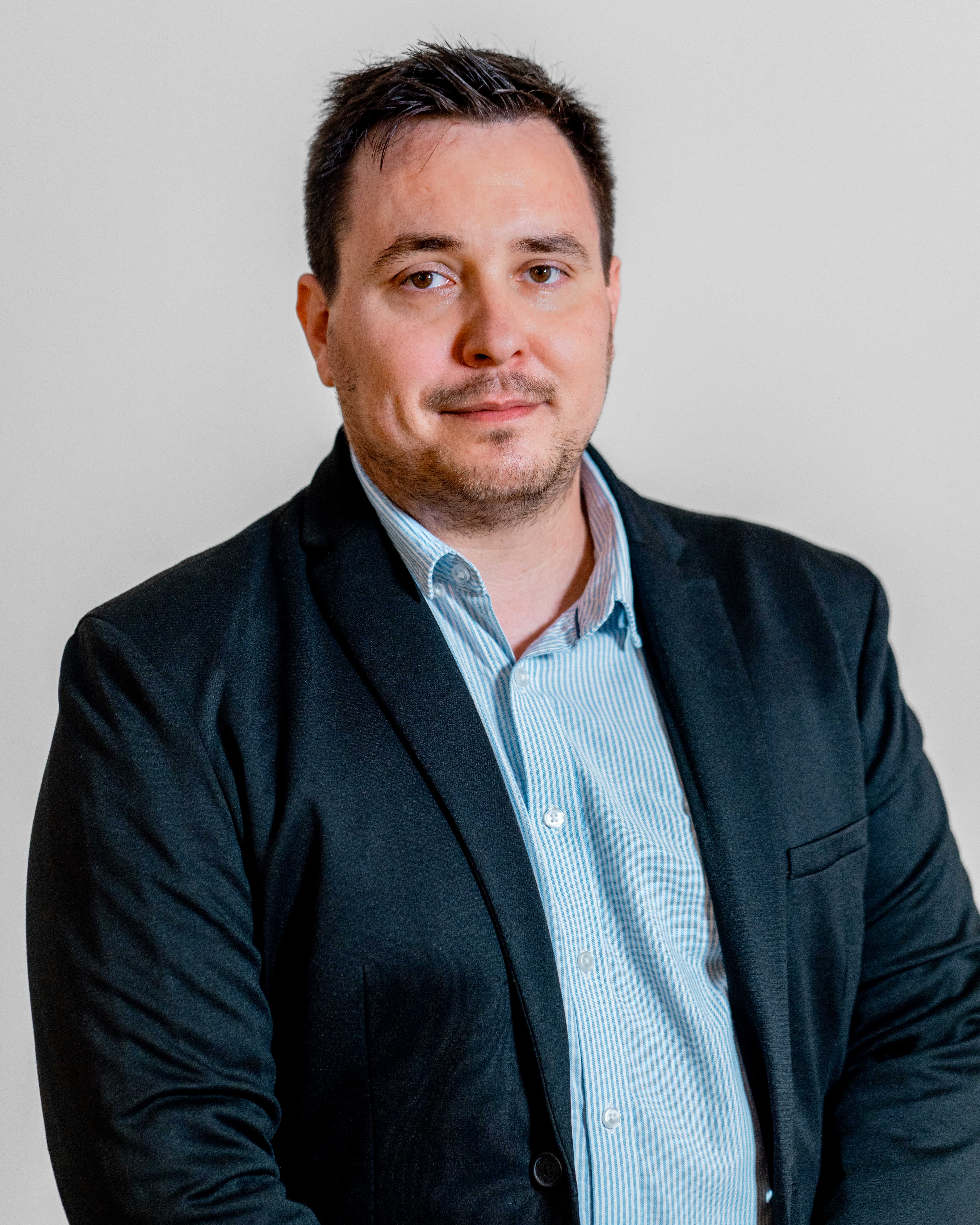 Professional portrait of Adam Larsen, a ServiceNow specialist.