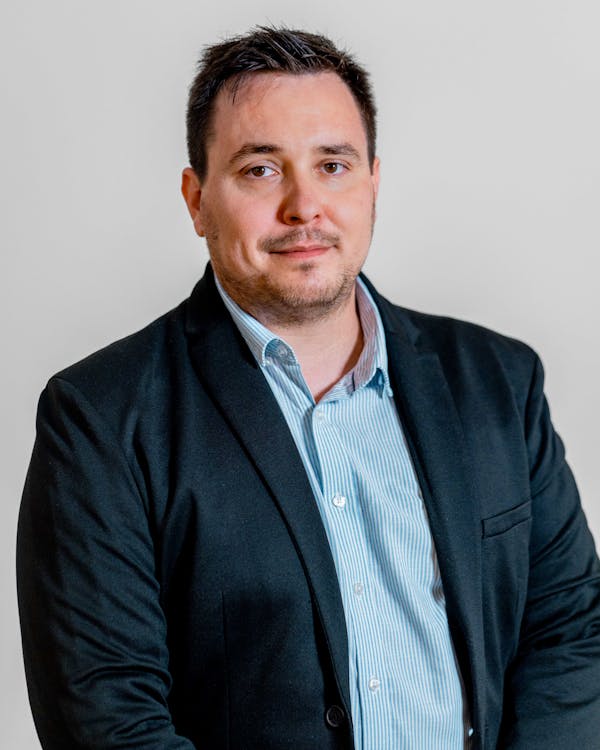 Professional portrait of Adam Larsen, a ServiceNow specialist.