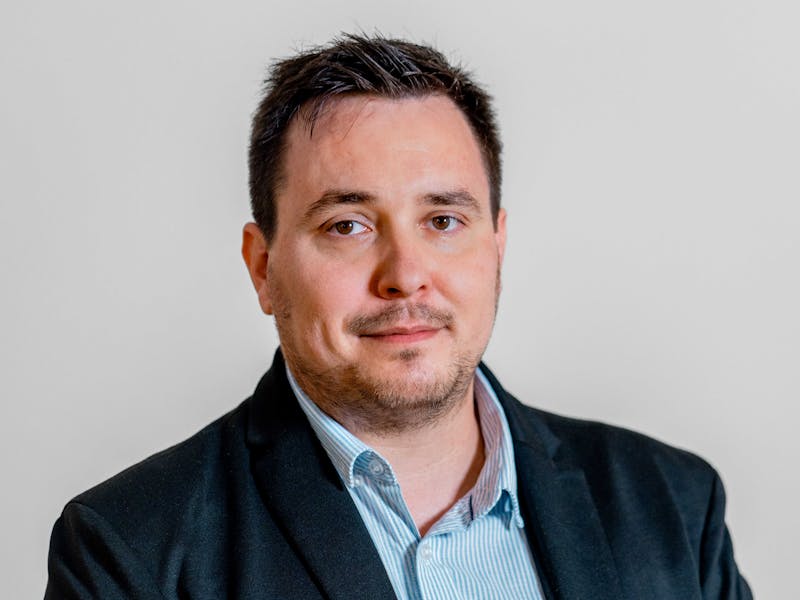 Professional portrait of Adam Larsen, a ServiceNow specialist.